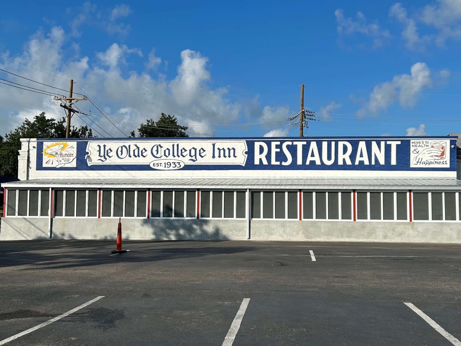 Sign for Ye Olde College Inn Restaurant, established in 1933, against a blue sky.