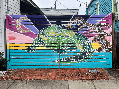 A colorful mural of a crocodile on a wooden gate, surrounded by vibrant gradients and patterns. A colorful mural of a crocodile on a wooden gate, surrounded by vibrant gradients and patterns.