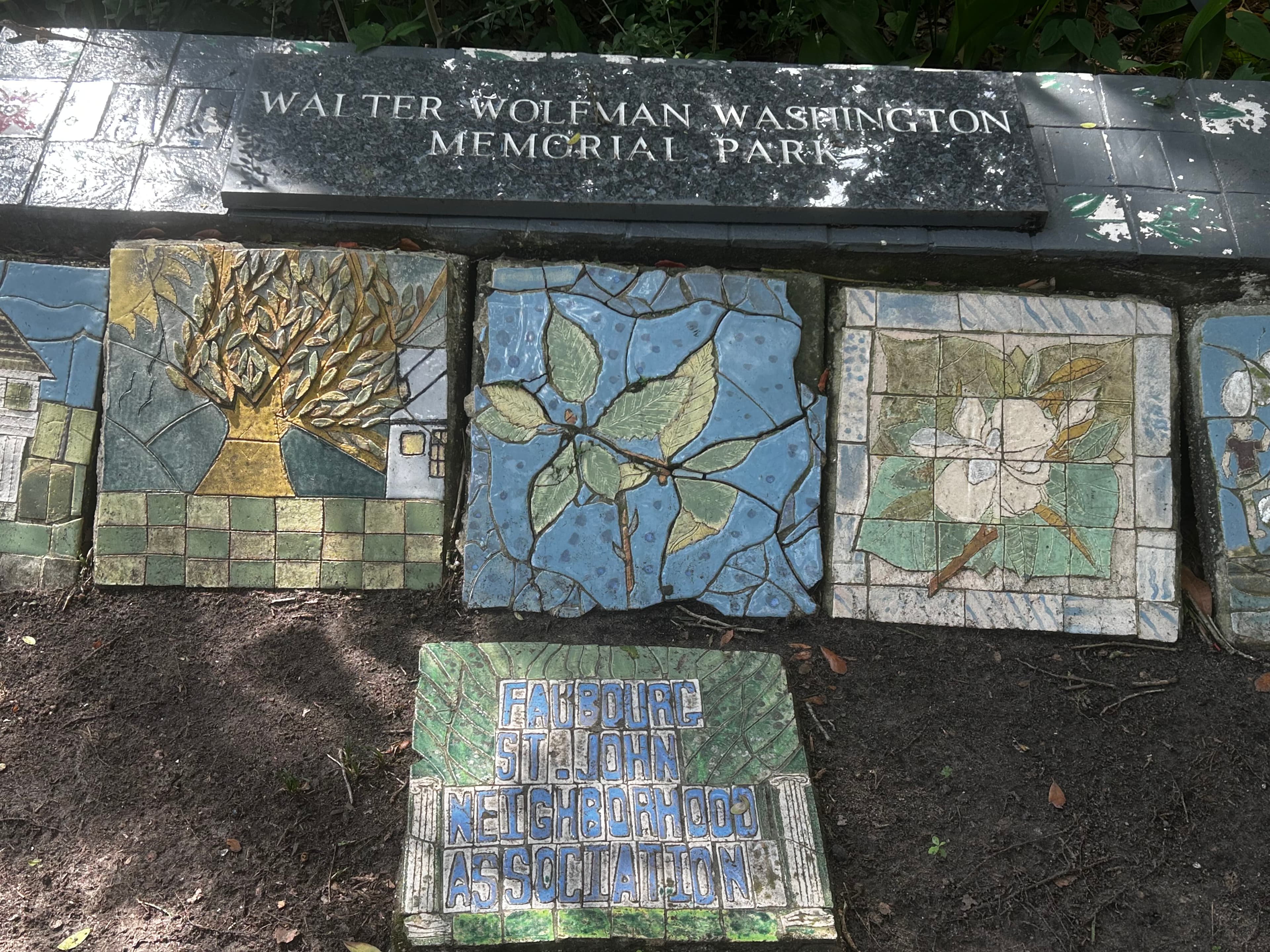 Mosaic tiles and a sign marking Walter Wolfman Washington Memorial Park.