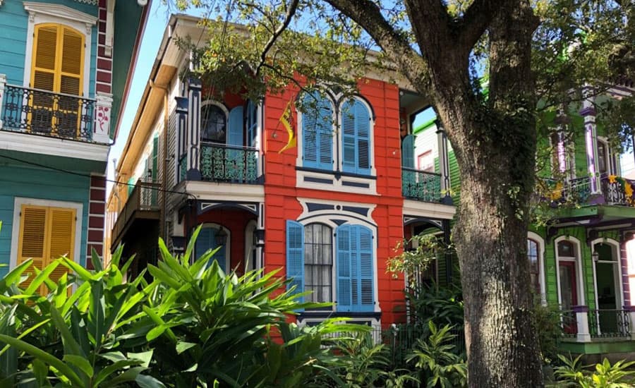 Colorful historic buildings surrounded by greenery.